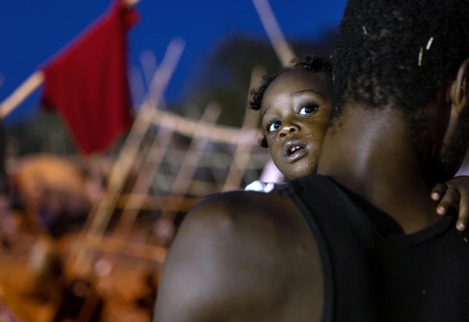 A father and daughter pass the evening inside a migrant camp at the US-Mexico border on 21 September 2021 in Del Rio, Texas (Getty Images)