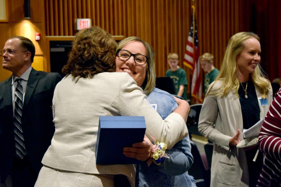 2022 Dr. John W. Harris Teacher of the Year Ashley Kracke, a R. F. Pettigrew Elementary School fifth grade teacher, embraced after being announced award winner at a ceremony in Axtell Park Building on Monday, March 14, 2022.