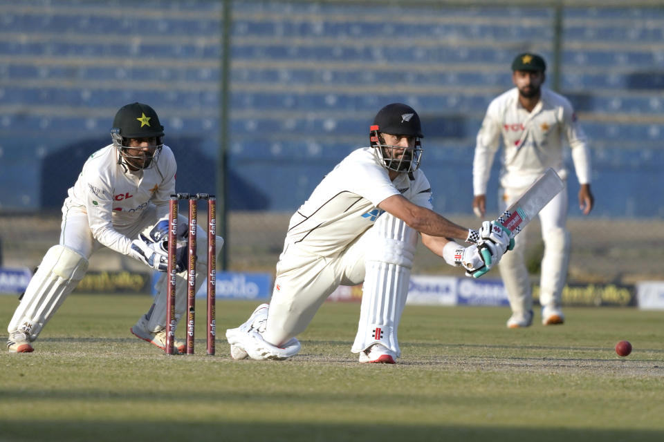 New Zealand's Daryl Mitchell, center, plays a reverse sweep shot during the fourth day of the second test cricket match between Pakistan and New Zealand, in Karachi, Pakistan, Thursday, Jan. 5, 2023. (AP Photo/Fareed Khan)