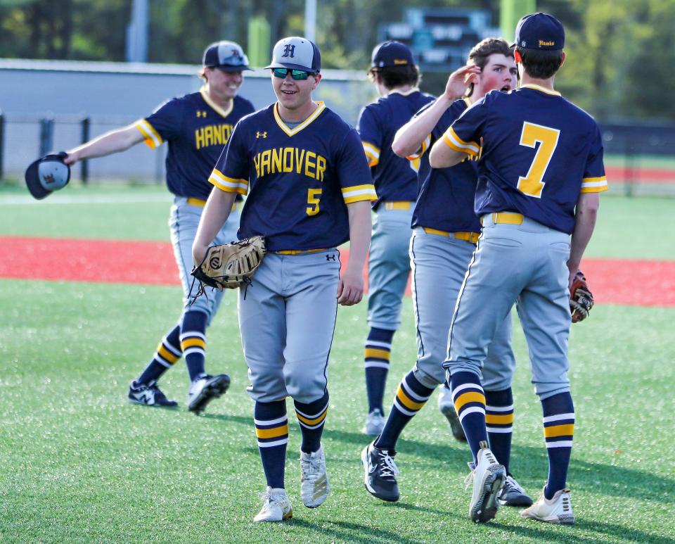 Hanover's Christian Henderson (5) and teammates celebrate a win over Plymouth South on Wednesday, May 18, 2022.