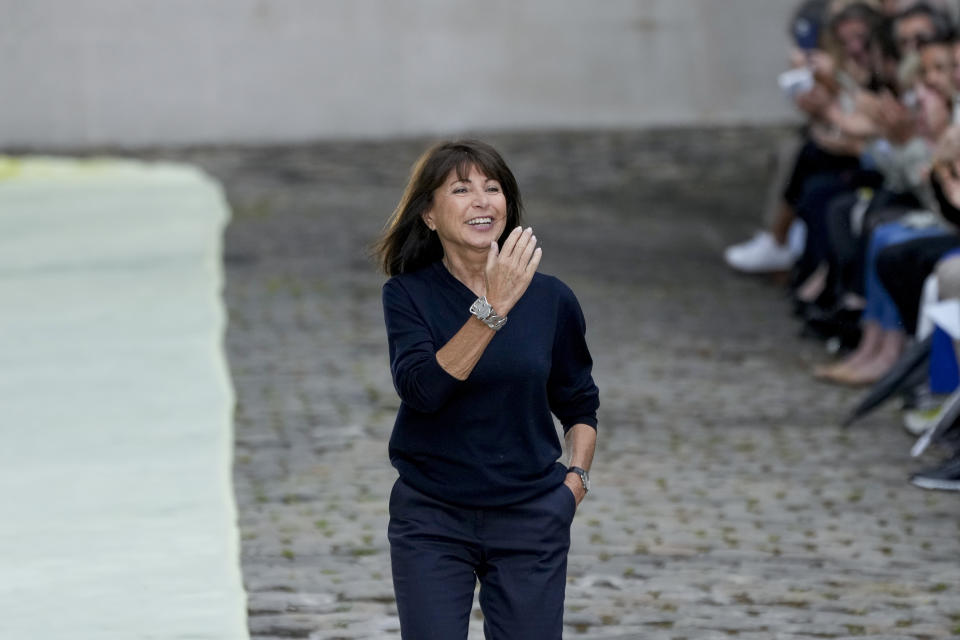 Designer Veronique Nichanian accepts applause at the end of the Hermes men's Spring Summer 2023 collection presented in Paris, France, Saturday, June 25, 2022. (AP Photo/Francois Mori)