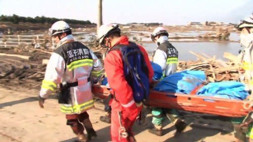 Japan battled a feared meltdown of two reactors at a quake-hit nuclear plant Sunday, as the full horror of the disaster emerged on the ravaged northeast coast where more than 10,000 were feared dead. 