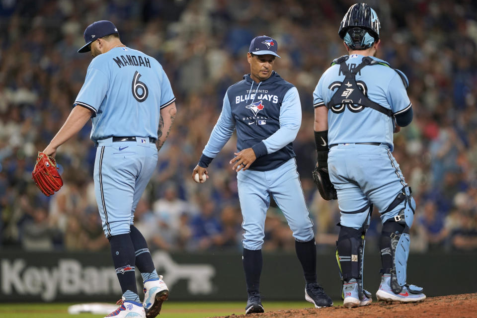 Toronto Blue Jays starting pitcher Alek Manoah (6) leaves after being pulled by manager Charlie Montoyo, center, as catcher Alejandro Kirk waits during the eighth inning of the team's baseball game against the Seattle Mariners, Saturday, July 9, 2022, in Seattle. The Mariners won 2-1. (AP Photo/Ted S. Warren)