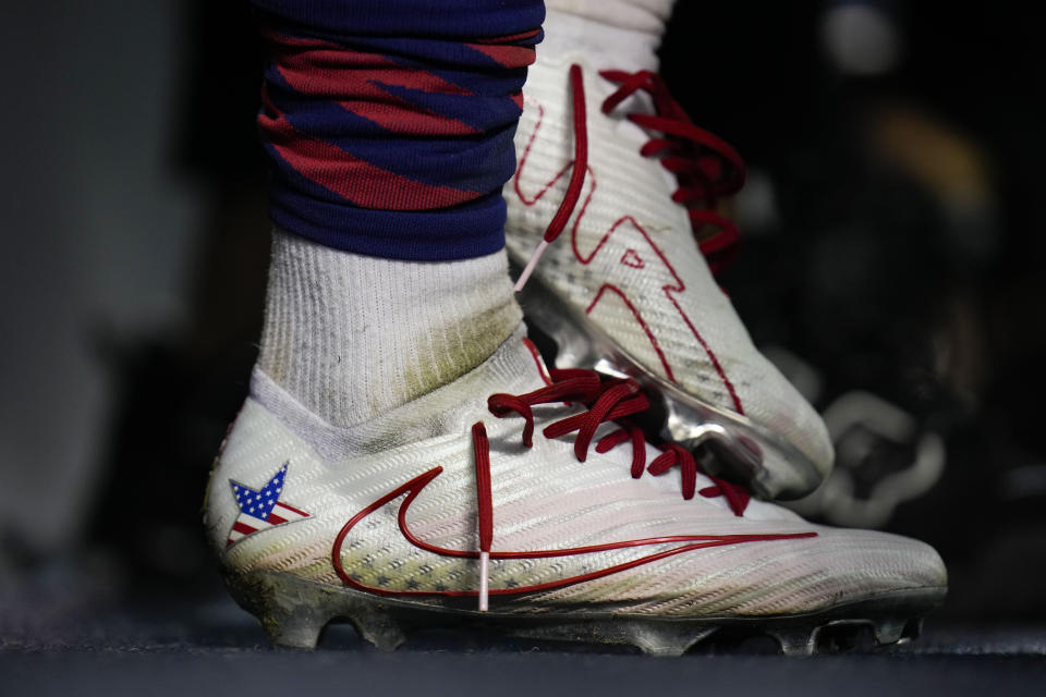 United States forward Megan Rapinoe plays with her cleats as she speaks to members of the press after a soccer game against South Africa, Sunday, Sept. 24, 2023, in Chicago. (AP Photo/Erin Hooley)