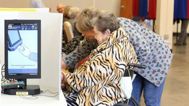 PHOTO: Election worker Rebecca Crockford helps Betty Greever with her provisional ballot at the Encampment Building on the Kansas State Fairgrounds, Nov. 2, 2021. (The Hutchinson via USA Today Network, FILE)