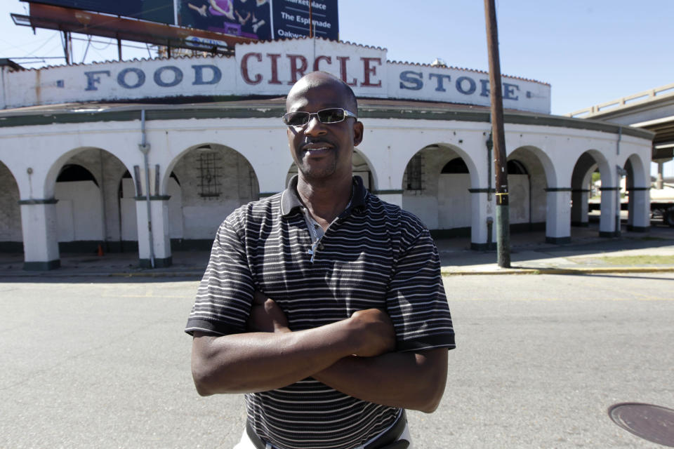 Dwayne Boudreaux poses outside his Circle Food Store, which was destroyed in Hurricane Katrina, as renovations begin for the stores' reopening, in New Orleans, Friday, Oct. 19, 2012. Circle’s barren insides are emblematic of a problem that neighborhood activists say was exacerbated by the catastrophe: In a city known for food, fresh produce and affordable groceries have long been hard to come by for some. (AP Photo/Gerald Herbert)