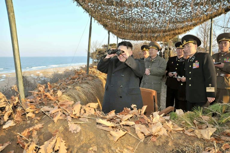 North Korean leader Kim Jong-Un (left) inspects military drills