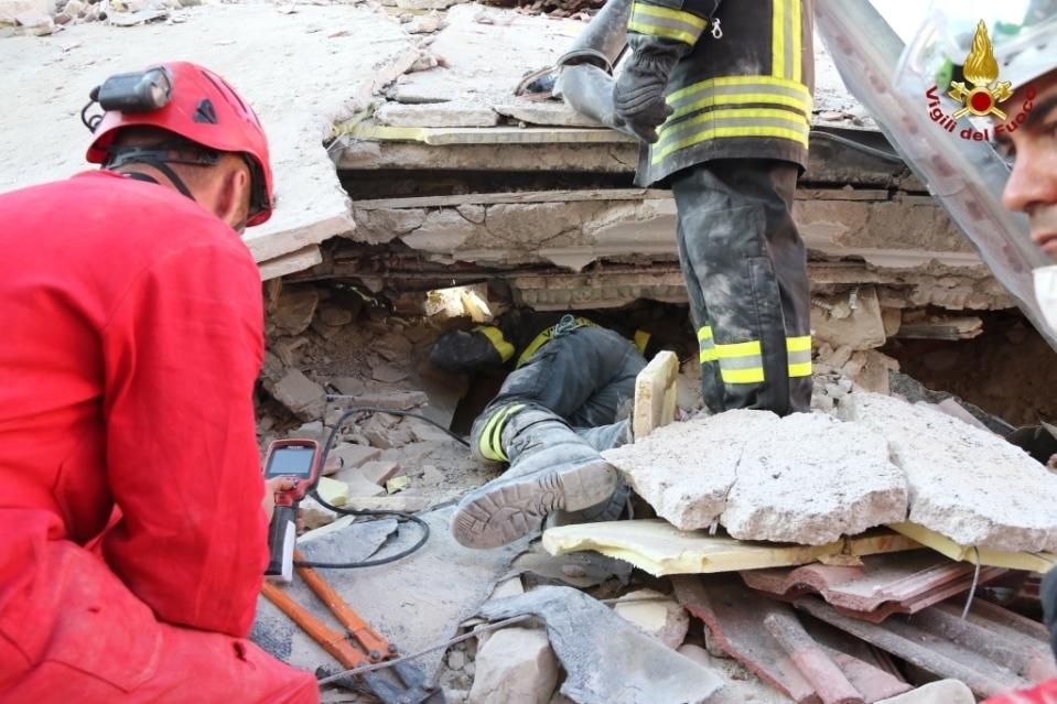 <p>Firefighters search through debris of a collapsed house in Amatrice, central Italy, Thursday, Aug. 25, 2016. (Italian Firefighters Vigili del Fuoco via AP) </p>