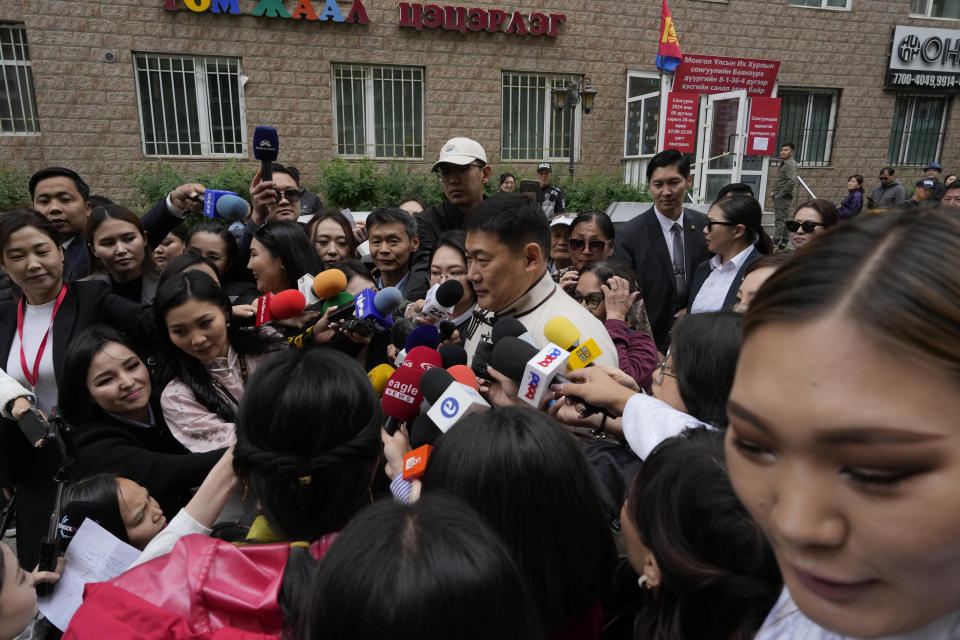 Mongolian Prime Minister Oyun-Erdene Luvsannamsrai, center, is surrounded by journalists after he cast his vote at a polling station in Ulaanbataar, Mongolia, Friday, June 28, 2024. Voters in Mongolia are electing a new parliament on Friday in their landlocked democracy that is squeezed between China and Russia, two much larger authoritarian states. (AP Photo/Ng Han Guan)