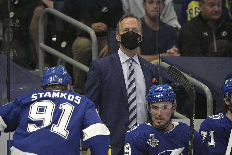 Tampa Bay Lightning head coach Jon Cooper watches from the bench during the second period in Game 1 of the NHL hockey Stanley Cup finals against the Montreal Canadiens, Monday, June 28, 2021, in Tampa, Fla. (AP Photo/Phelan Ebenhack)