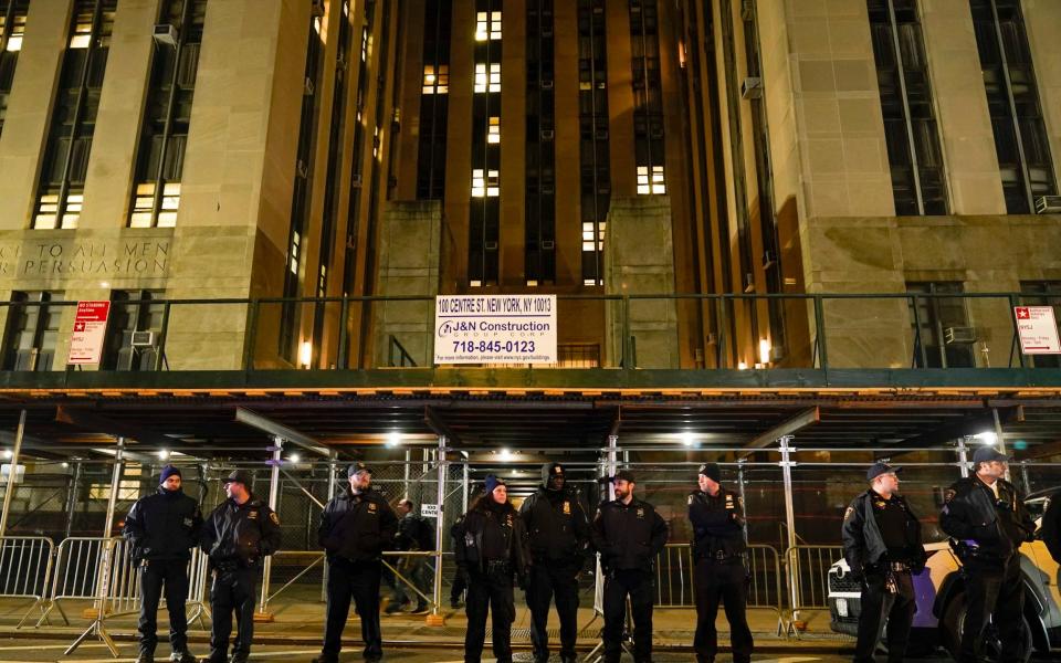 Court officers stand guard outside the Manhattan criminal courts building - AP Photo/Mary Altaffer