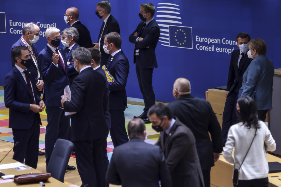 French President Emmanuel Macron, third right, speaks with German Chancellor Angela Merkel, second right, during a round table meeting at an EU summit at the European Council building in Brussels, Thursday, Oct. 15, 2020. European Union leaders are meeting in person for a two-day summit amid the worsening coronavirus pandemic to discuss topics ranging from Brexit to climate and relations with Africa. (Kenzo Tribouillard, Pool via AP)