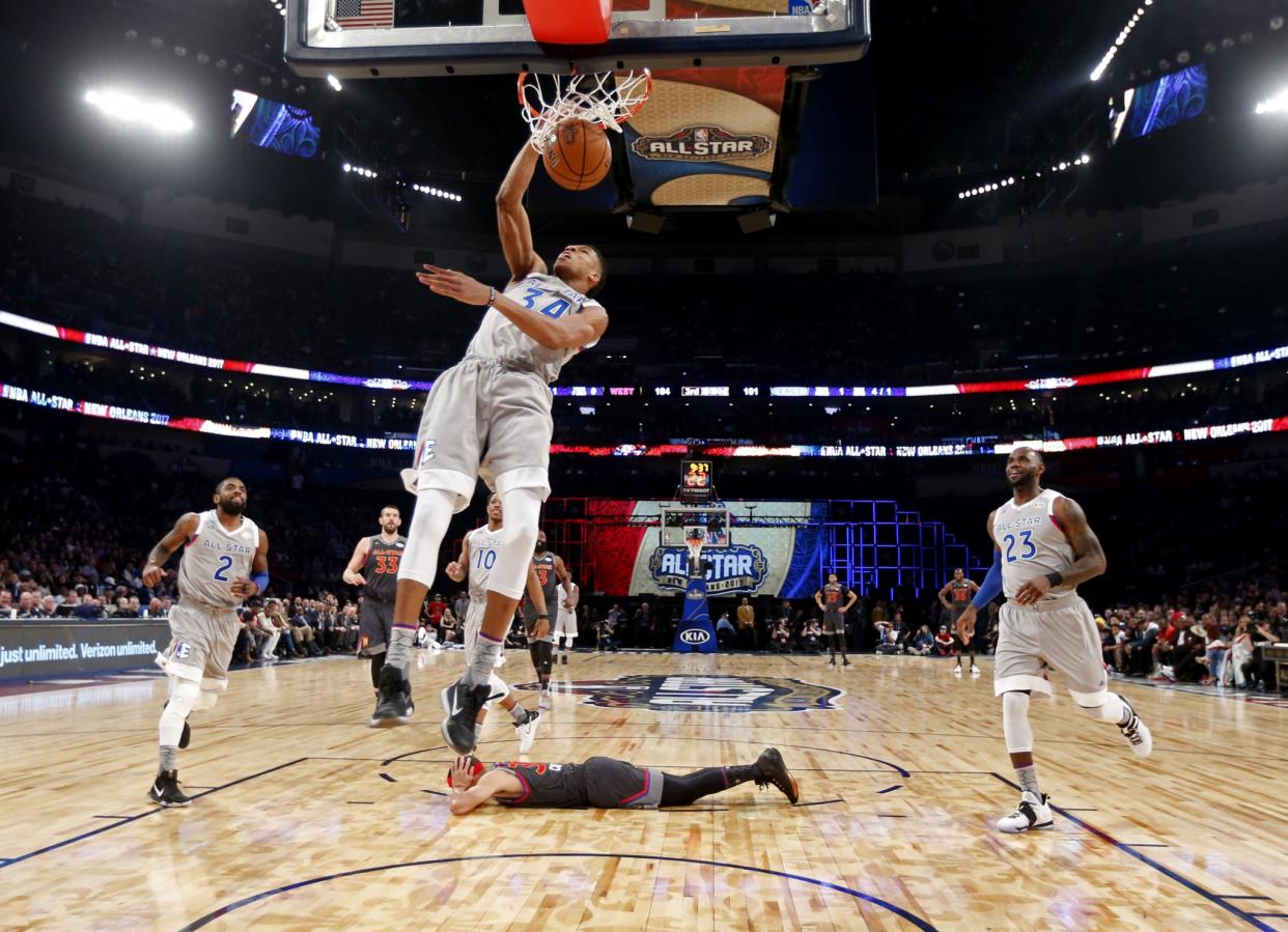 Stephen Curry (prostrate) displays an All-Star Game-appropriate commitment to defense. (AP)