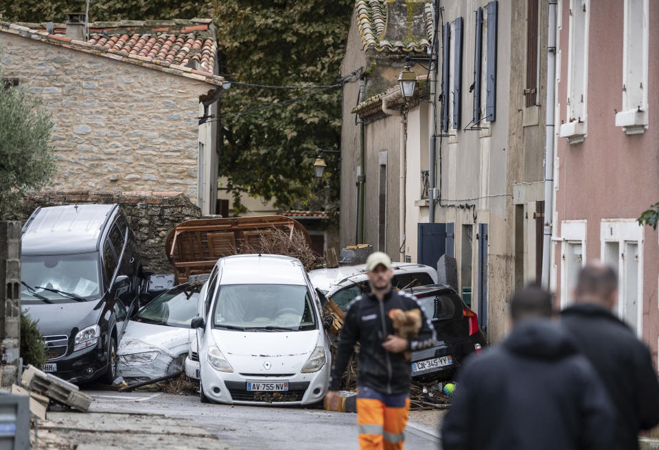 Cars pile up after flash floods in the town of Villegailhenc, southern France, Monday, Oct.15, 2018. Flash floods tore through towns in southwest France, turning streams into raging torrents that authorities said killed several people and seriously injured at least five others. (AP Photo/Fred Lancelot)