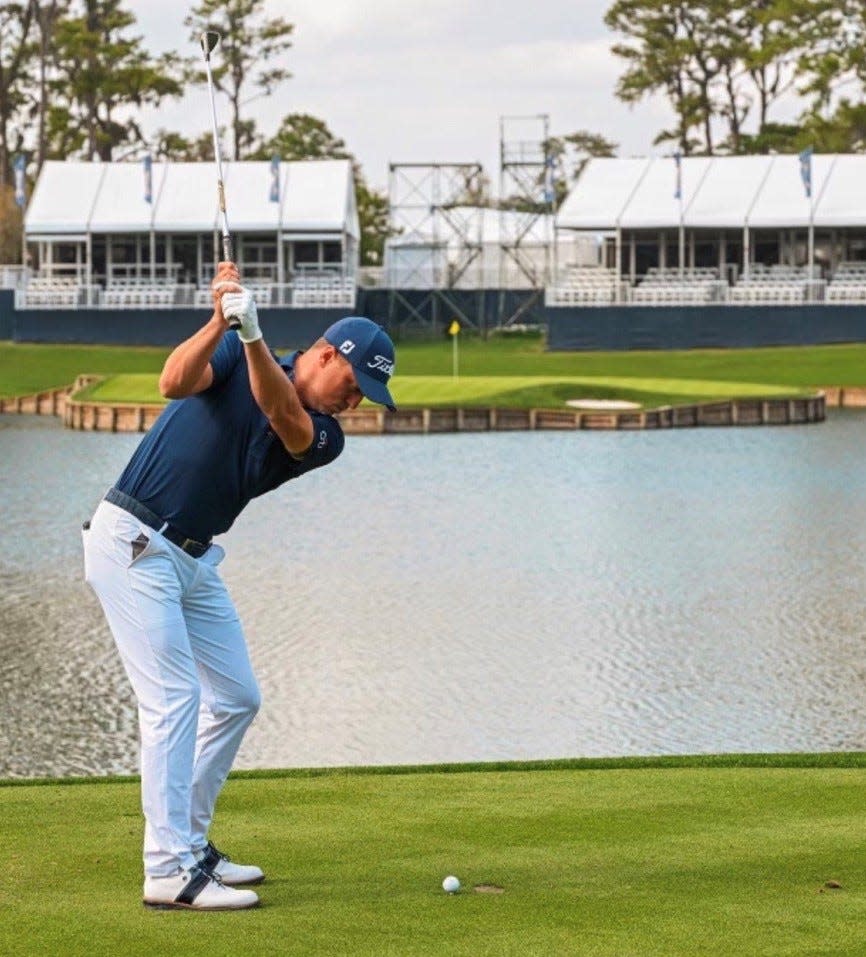 Justin Thomas hits a shot to the Island Green at No. 17 of the Players Stadium Course while filming a promotional video for the PGA Tour in 2022.