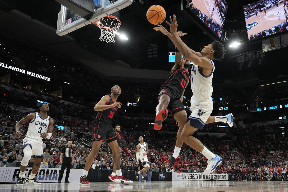 Villanova forward Jermaine Samuels, right, shoots over Houston forward J'Wan Roberts during the second half of a college basketball game in the Elite Eight round of the NCAA tournament on Saturday, March 26, 2022, in San Antonio. (AP Photo/Eric Gay)