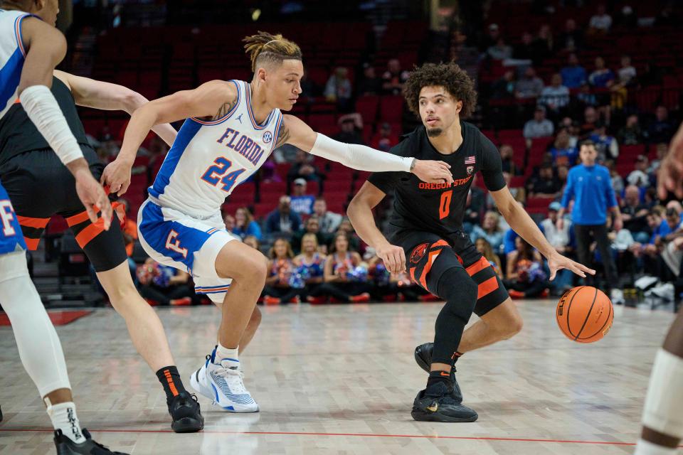 Oregon State Beavers guard Jordan Pope (0) dribbles the ball during the second half against Florida Gators guard Riley Kugel (24) at the Moda Center Nov. 25, 2022, in Portland.