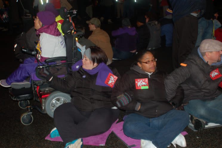 Sumer Spike blocking traffic in Minneapolis. (Photo: Courtesy of the Fight for $15)