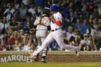 Chicago Cubs' Christopher Morel scores past Baltimore Orioles catcher Adley Rutschman on Rafael Ortega's sacrifice fly during the fifth inning of a baseball game Wednesday, July 13, 2022, in Chicago. (AP Photo/Charles Rex Arbogast)