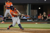 Houston Astros' Jose Altuve hits a three-run home run against the Texas Rangers during the ninth inning in Game 5 of the baseball American League Championship Series Friday, Oct. 20, 2023, in Arlington, Texas. (AP Photo/Godofredo A. Vásquez)