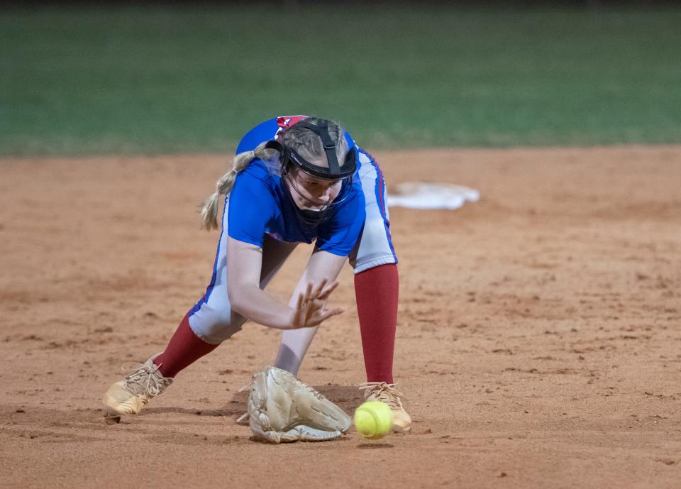 Shortstop Tatum Hasting (7) scoops up a grounder during the Gulf Breeze vs Pace softball game at Pace High School on Thursday, April 7, 2022.