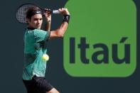 Mar 30, 2017; Miami, FL, USA; Roger Federer of Switzerland hits a backhand against Tomas Berdych of the Czech Republic (not pictured) in a men's singles quarter-final during the 2017 Miami Open at Crandon Park Tennis Center. Federer won 6-2, 3-6, 7-6(6). Mandatory Credit: Geoff Burke-USA TODAY Sports