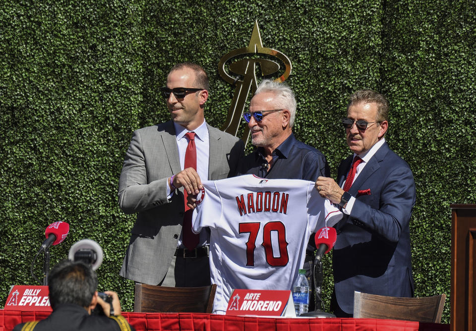 Los Angeles Angels general manager Billy Eppler, left, and team owner Arte Moreno, right, introduce the baseball team's new manager, Joe Maddon, during a news conference at Angel Stadium in Anaheim, Calif., Thursday, Oct. 24, 2019. (Jeff Gritchen/The Orange County Register via AP)