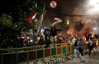 FILE PHOTO: Protesters demonstrate after a students' rally in Jakarta