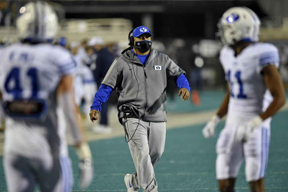 BYU head coach Kalani Sitake, center, walks on the field during the first half of an NCAA college football game against Coastal Carolina Saturday, Dec. 5, 2020, in Conway, S.C. (AP Photo/Richard Shiro)