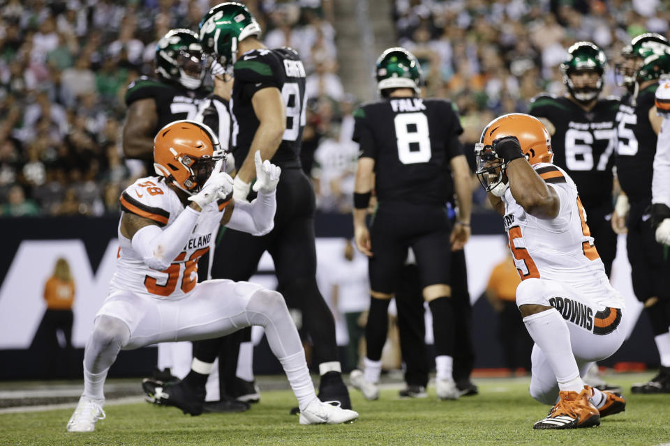 Cleveland Browns' Christian Kirksey (58) celebrates with Myles Garrett (95) after Garrett sacked New York Jets' quarterback Luke Falk (8) during the second half of an NFL football game Monday, Sept. 16, 2019, in East Rutherford, N.J. (AP Photo/Adam Hunger)