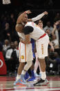 Atlanta Hawks guard Vince Carter, right, celebrates with Trae Young after hitting a basket in overtime of an NBA basketball game against the New York Knicks Wednesday, March 11, 2020, in Atlanta. (AP Photo/John Bazemore)