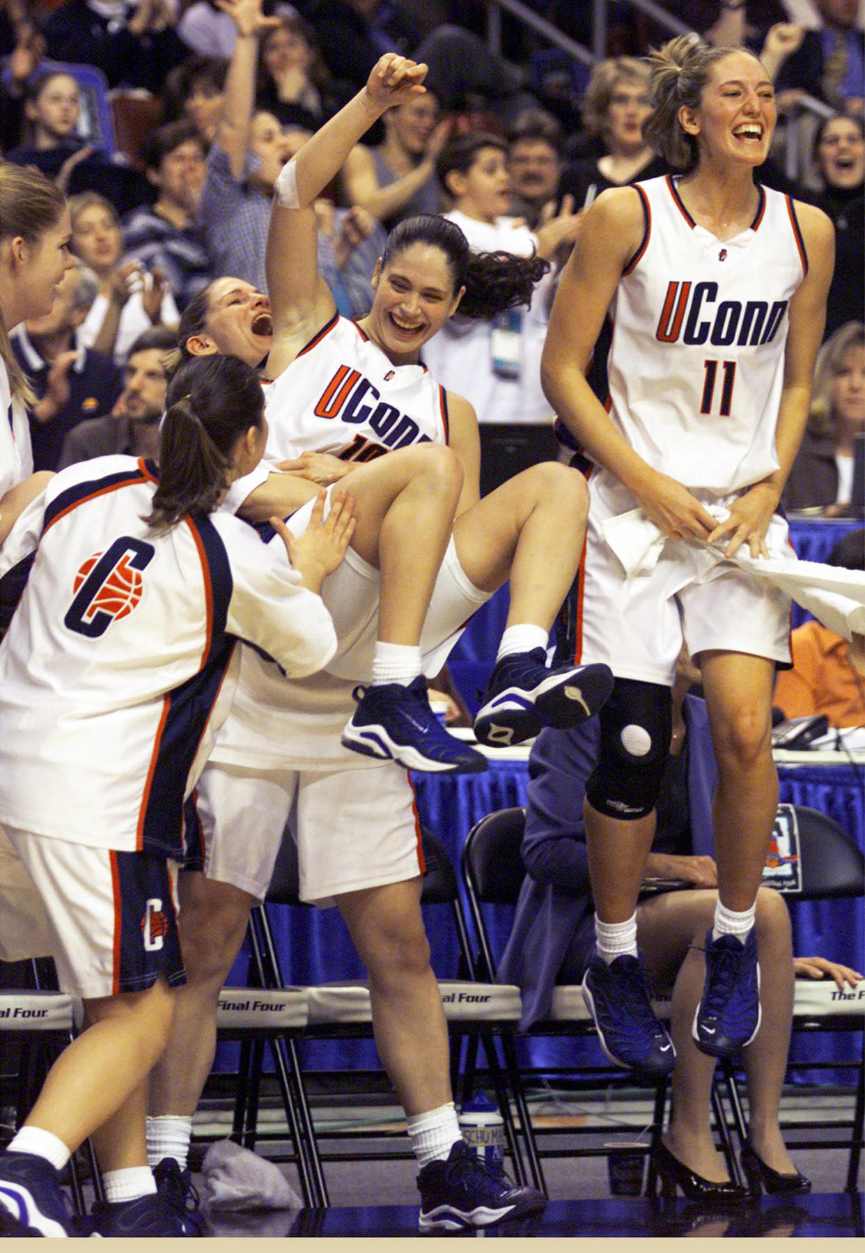 Stacy Hansmeyer holds up Sue Bird (Hartford Courant / Getty Images)