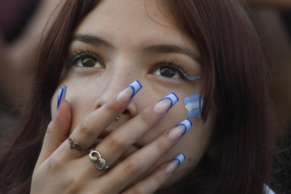 An Argentine soccer fan watches her team's match against Mexico at the World Cup, hosted by Qatar, in Buenos Aires, Argentina, Saturday, Nov. 26, 2022. (AP Photo/Gustavo Garello)