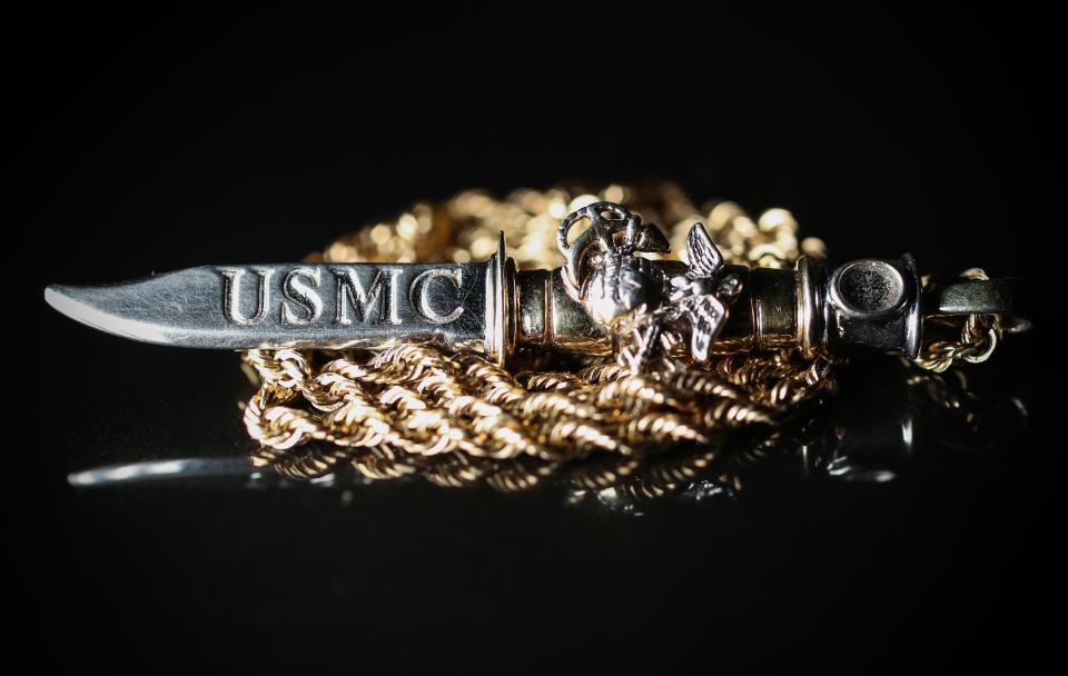 A necklace belonging to Vietnam veteran Fred Norris rests on a coffee table Friday, April 22, 2022, inside his east side Indianapolis home. The knife, called a Ka-Bar, is a knife that Norris and all his fellow Marine soldiers carried.