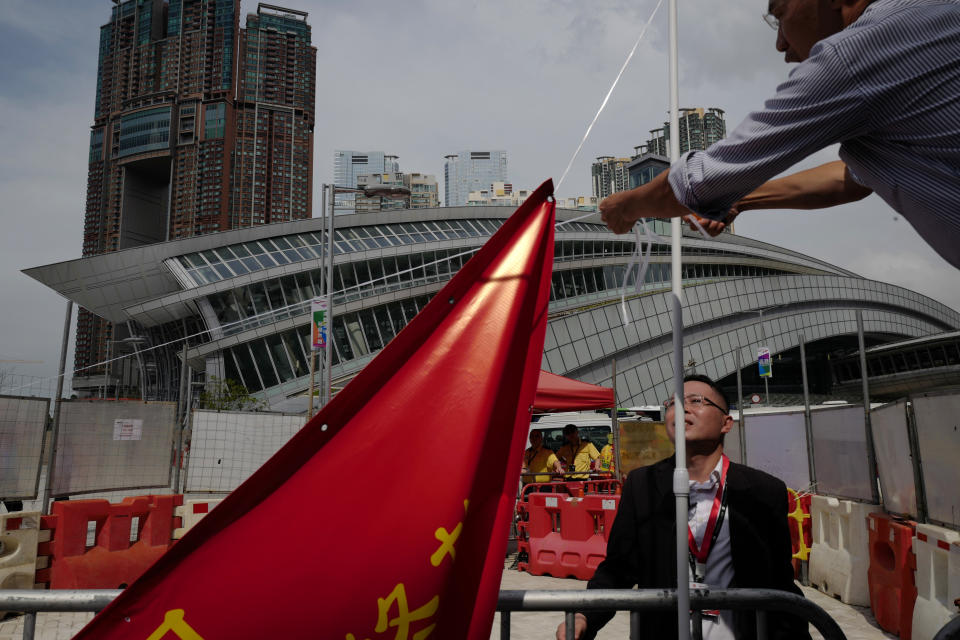 A protester removes a banner after a protest outside the Western Kowloon Station against the opening ceremony of the Hong Kong Express Rail Link in Hong Kong, Saturday, Sept. 22, 2018. Hong Kong has opened a new high-speed rail link to inland China that will vastly decrease travel times but which also raises concerns about Beijing's creeping influence over the semi-autonomous Chinese region. (AP Photo/Vincent Yu)