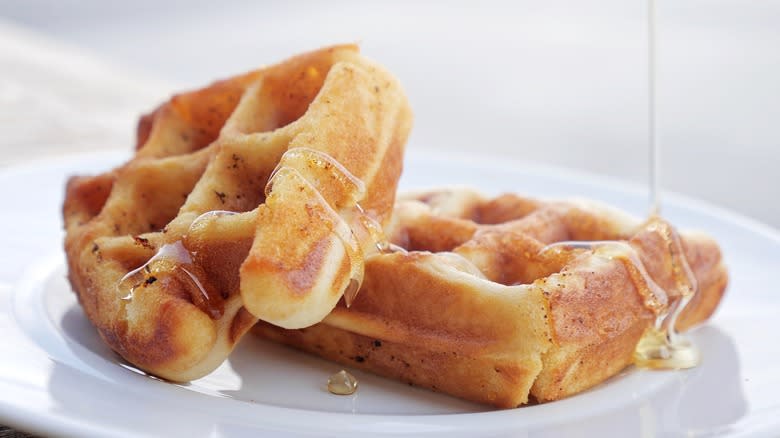 Belgian waffle slices with syrup drizzling