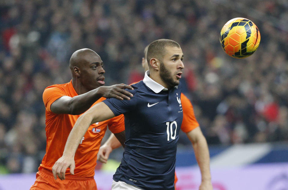 Karim Benzema of France, right, and Netherlands' Bruno Martins Indi eye the ball during the international friendly match between France and Netherlands at the Stade de France stadium, outside Paris, Wednesday, March 5, 2014. (AP Photo/Christophe Ena)