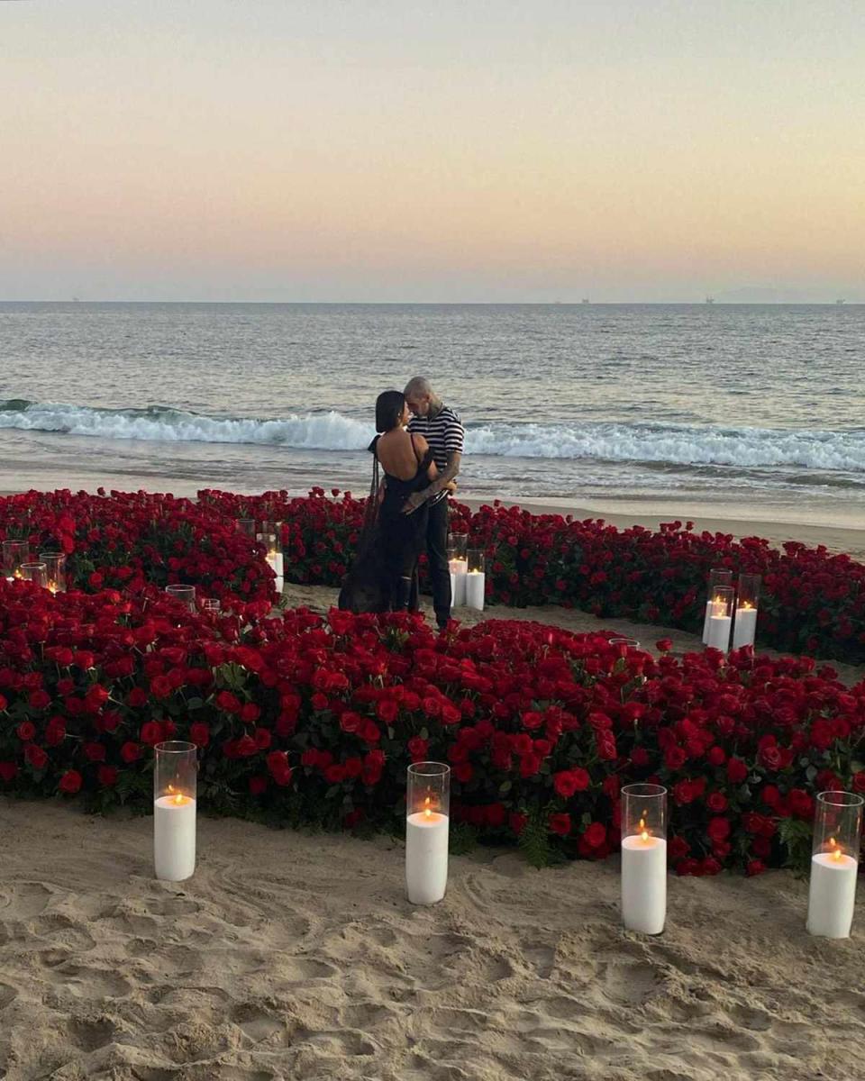 <p>Roses, candles, a seaside sunset ... are you <em>Keeping Up </em>with all the requisite elements of an ultra-romantic proposal, à la Travis Barker? </p> <p>The "All the Small Things" rocker opted for a grand gesture when he <a href="https://people.com/tv/kourtney-kardashian-and-travis-barker-engagement-photos/" rel="nofollow noopener" target="_blank" data-ylk="slk:popped the question;elm:context_link;itc:0;sec:content-canvas" class="link ">popped the question</a> to Kourtney Kardashian on Oct. 17, during a weekend getaway at one of their favorite hotels, the Rosewood Miramar in Montecito, California. </p> <p>Barker set up a veritable rose garden beside the sea, with the flowers arranged into an enormous heart and surrounded by candles. His proposal came less than one year after PEOPLE confirmed the longtime friends were <a href="https://people.com/webstory/kourtney-kardashian-travis-barker-relationship-timeline/" rel="nofollow noopener" target="_blank" data-ylk="slk:dating in January.;elm:context_link;itc:0;sec:content-canvas" class="link ">dating in January.</a></p>