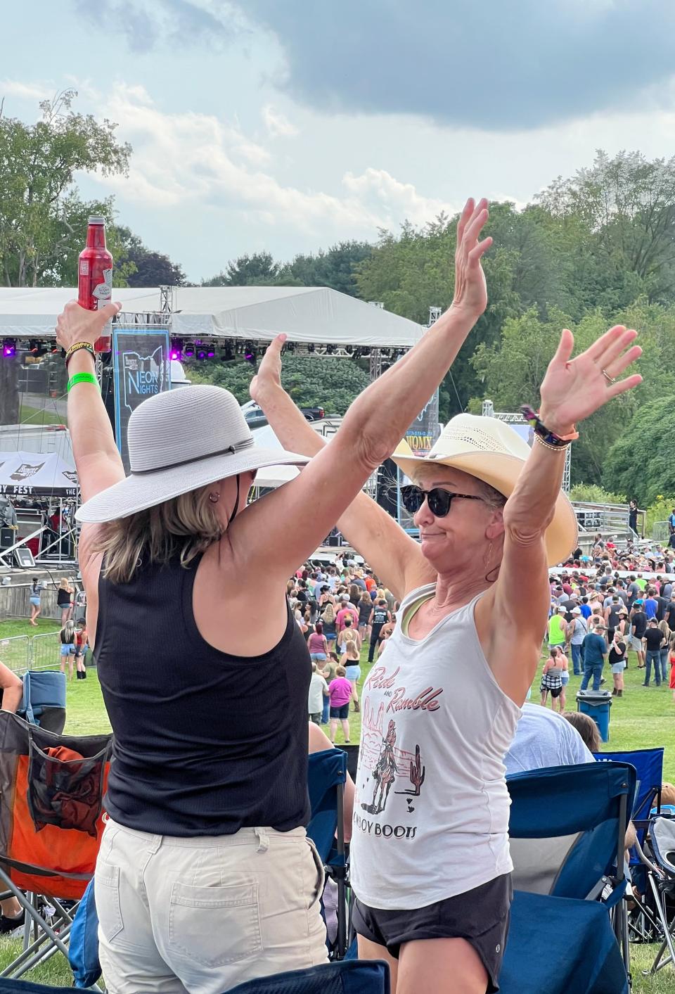Country music fans enjoy the Neon Nights music festival on Friday. The event continues Saturday at Clay's Resort Jellystone Park with Wynonna Judd, Tim McGraw and other country music artists.