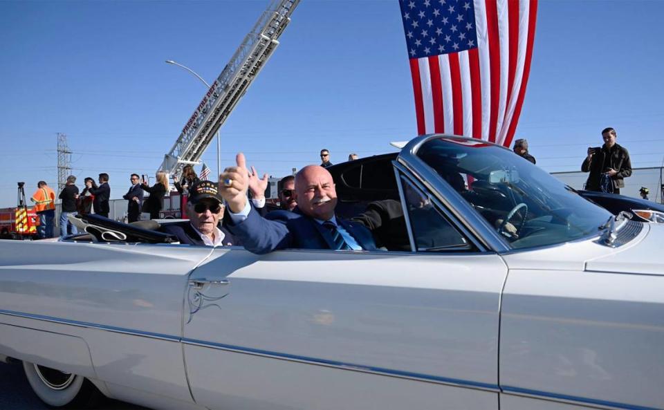 Fresno Mayor Jerry Dyer gives a thumbs up as he and others including former County Supervisor Phil Larson, seated behind Dyer, lead a parade over the Veterans Boulevard overpass after the ribbon-cutting ceremony for the opening of Veterans Boulevard Monday, Nov. 20, 2023 in Fresno.