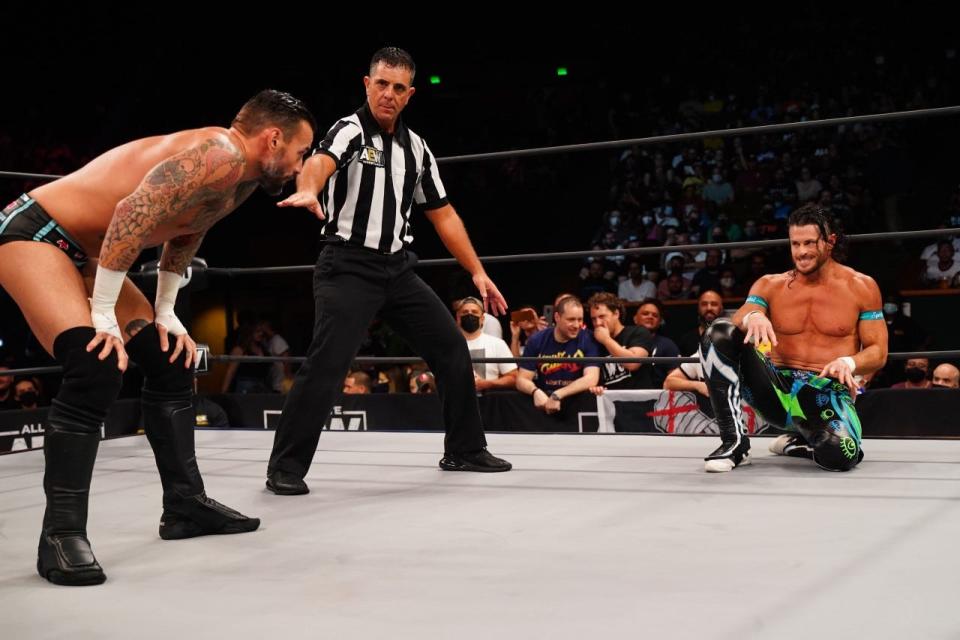 Matt Sydal, right, a Mizzou graduate and St. Louis native, stares across the ring at CM Punk, left, during an episode of All Elite Wrestling Rampage on Oct. 15 in Miami. Also pictured is AEW referee Paul Turner.