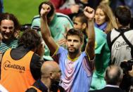 Barcelona's defender Gerard Pique celebrates after the Spanish League football match against Levante at Ciutat de Valencia stadium in Valencia. Barcelona were crowned Spanish champions for the third successive season with a 1-1 draw at Levante clinching a 21st domestic title with two games to spare