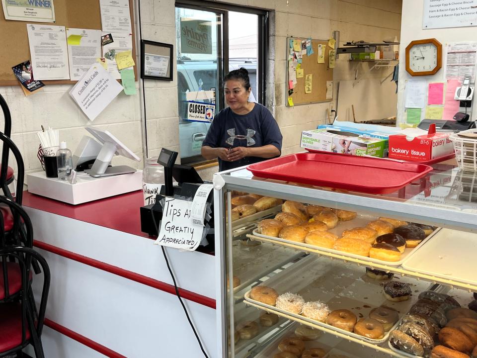 Manager Pearl Sullivan works a steady drive-thru line at The Donut Palace in Lebanon, Tennessee.