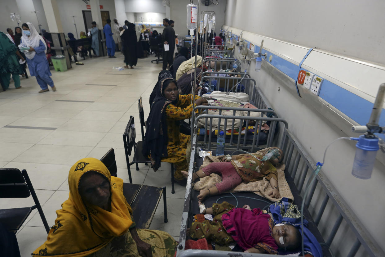 Children in hospital beds are treated after their family homes were hit by flooding in Larkana District, of Sindh, Pakistan, Thursday, Sept. 8, 2022. (AP Photo/Fareed Khan)