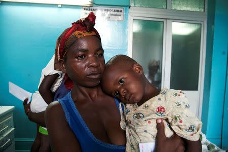 A mother holds her child suffering from yellow fever at a hospital in Luanda?, Angola, March 15, 2016. REUTERS/Herculano Coroado