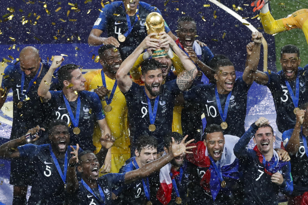 France's Olivier Giroud holds up the trophy as he celebrates with teammates at the end of the final match between France and Croatia at the 2018 soccer World Cup in the Luzhniki Stadium in Moscow, Russia, Sunday, July 15, 2018. (AP Photo/Rebecca Blackwell)