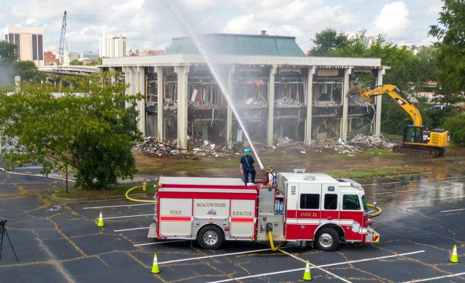 A Macon-Bibb County excavator begins the tear down of the former Greater Chamber of Commerce building Wednesday morning located at 305 Coliseum Drive. The removal of the building will increase parking for the Macon Coliseum.