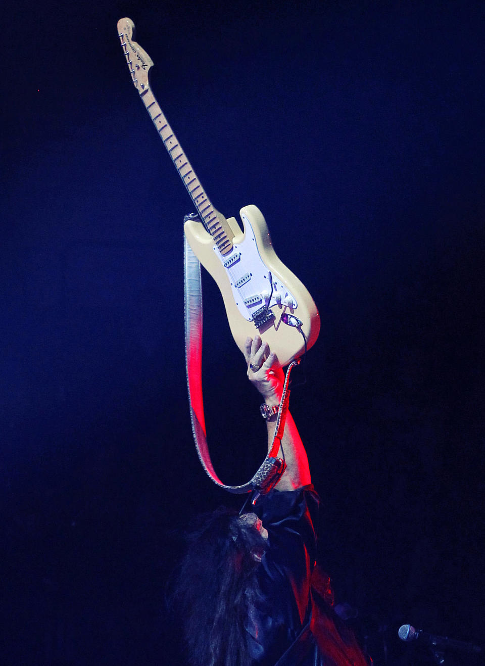 Swedish guitar virtuoso Yngwie Malmsteen holds his Fender Stratocaster up as he finishes his performance at Wembley Arena in London on Saturday, Sept. 22, 2012. Commenting on the 60-year history of the Stratocaster, Malmsteen says, "The Strat's the original, and still the best, most beautiful, amazing, perfect electrical guitar period." (AP Photo/Matt York)