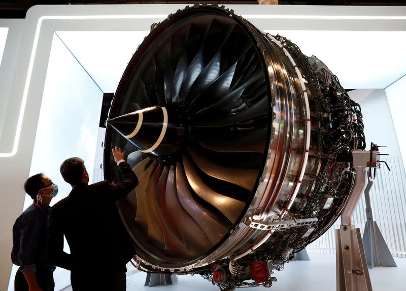 FILE PHOTO: People look at Rolls Royce's Trent Engine displayed at the Singapore Airshow in Singapore