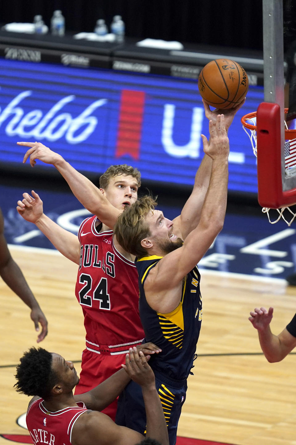 Indiana Pacers' Domantas Sabonis, right, scores past Chicago Bulls' Lauri Markkanen during the second half of an NBA basketball game Saturday, Dec. 26, 2020, in Chicago. (AP Photo/Charles Rex Arbogast)